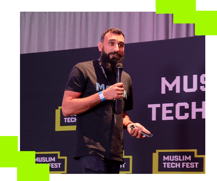 Image of man on stage at Muslim Tech Fest 24 being recorded during his talk