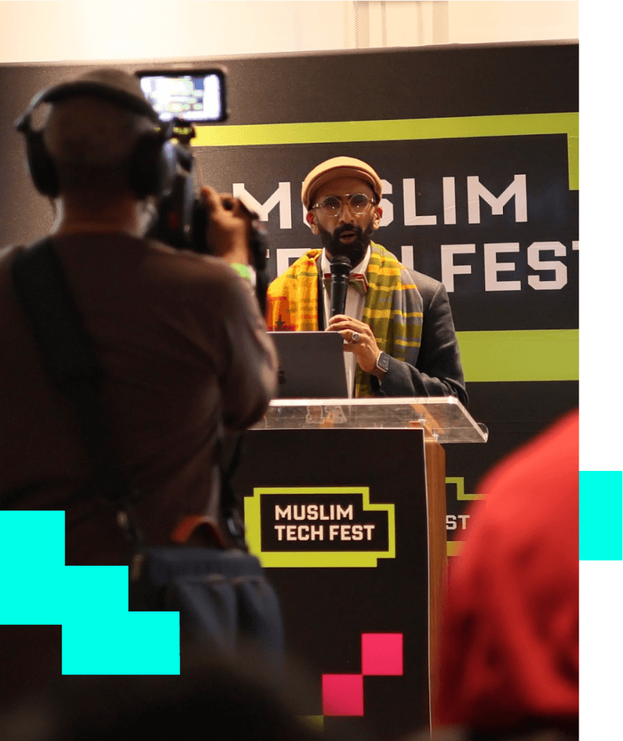 Image of man on stage at Muslim Tech Fest 24 being recorded during his talk